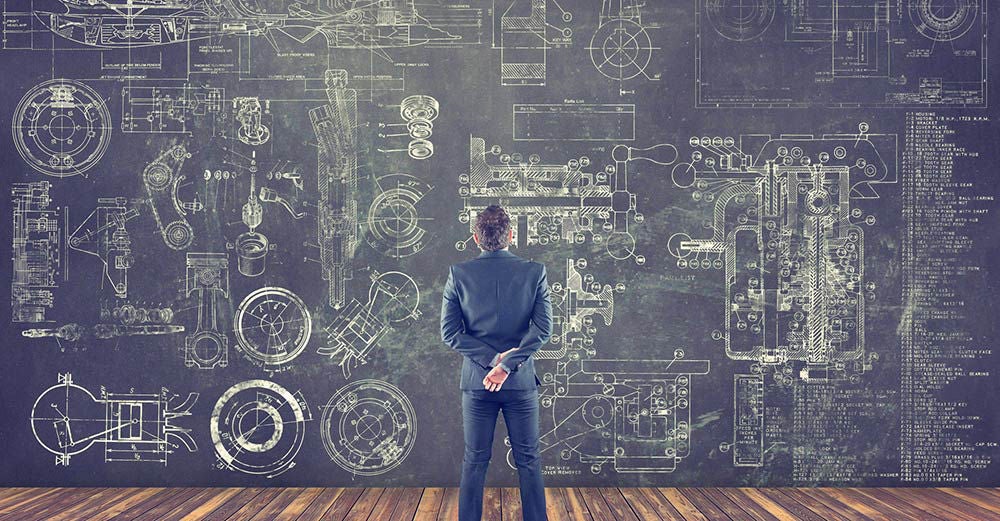 Man looking over wall of design schematics