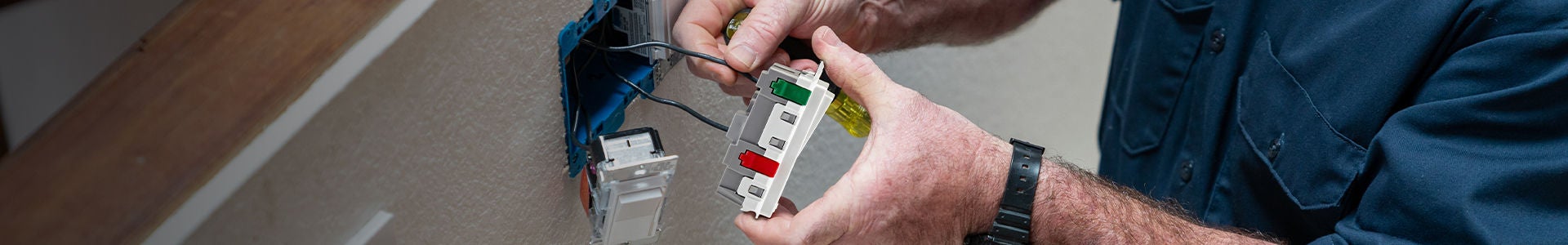 Image of man installing Lever Edge outlet