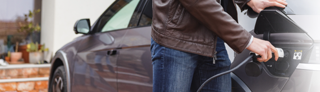 Man Charging Car with Leviton EV Charger