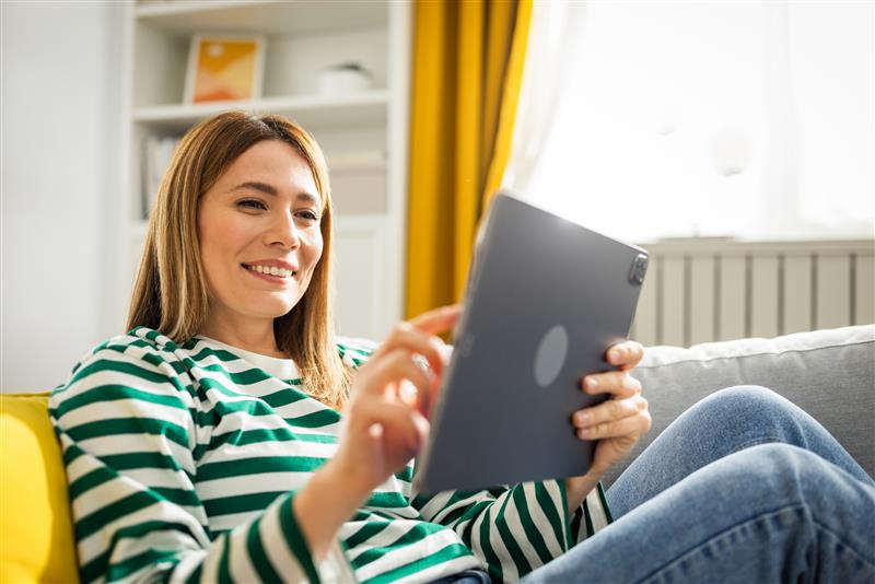 Man controlling smart device from tablet