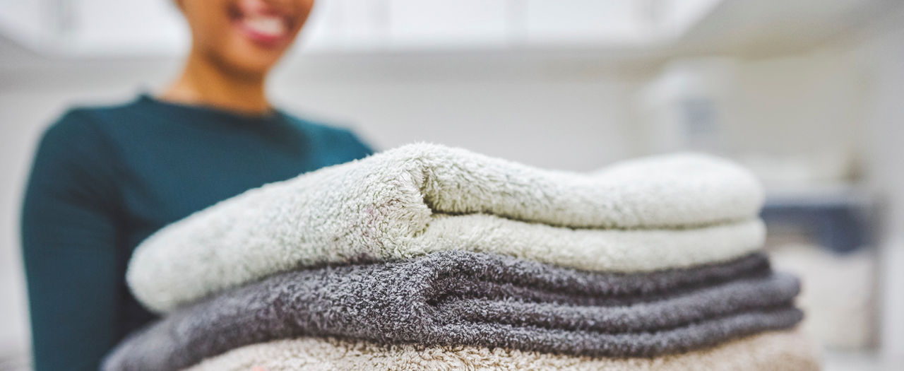 Women holding folded laundry