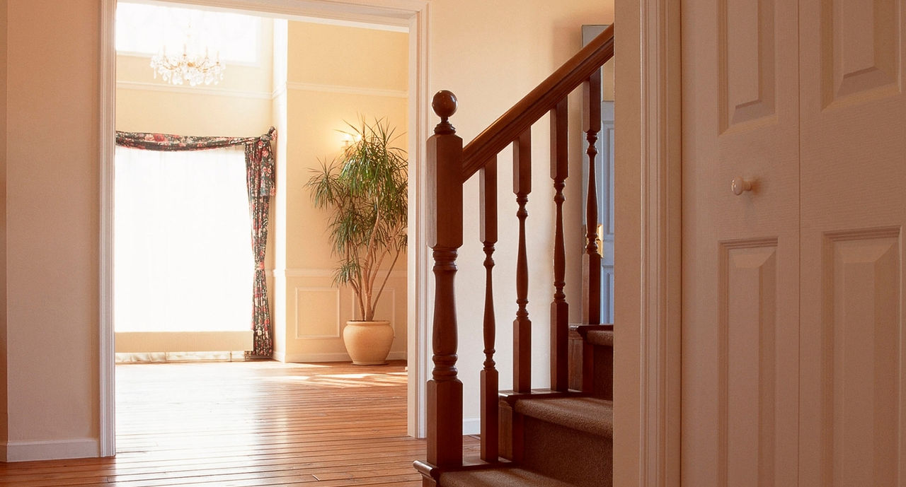 Hallway with stairs and overhead lighting