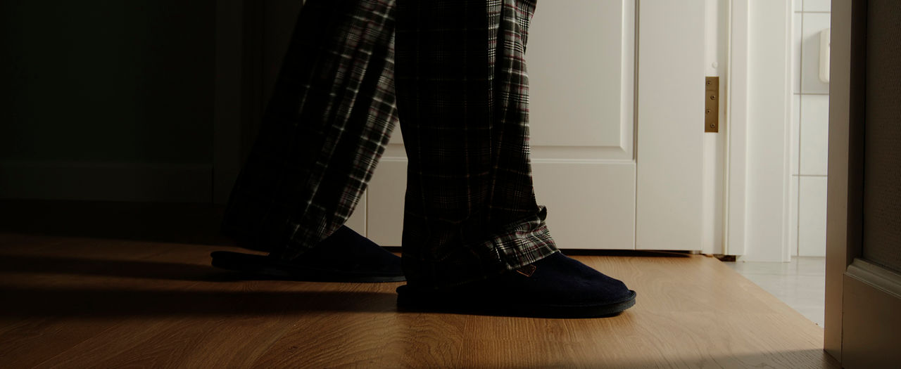 Person walking into a bathroom with lights on