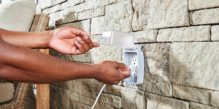 Person plugging charger into Leviton USB Outlet